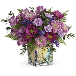 Purple mixed bouquet in a butterfly-printed square vase