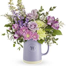 Lavender and pink bouquet in a purple pitcher vase