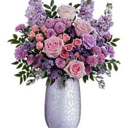 Pink and lavender flower arrangement in a tall silver vase