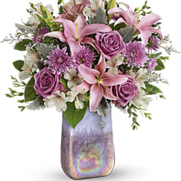 Pink lilies and roses in a decorative vase