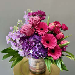Pink and purple bouquet in a glass vase