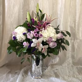 Mixed pink and white floral arrangement in a silver vase