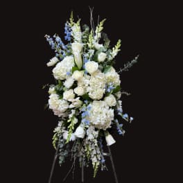 Tall white and blue floral spray on a stand