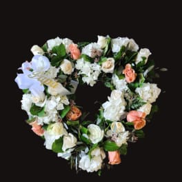 Heart-shaped floral wreath with white and peach roses