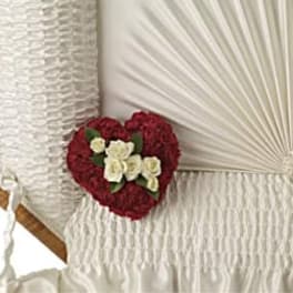 Heart-shaped floral arrangement with red and white flowers