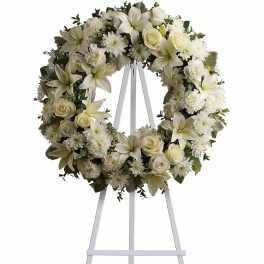 White floral wreath on a standing easel
