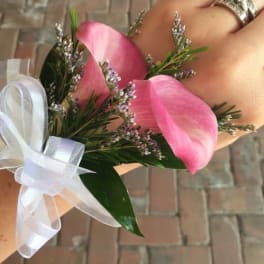 Pink calla lily wrist corsage with white ribbon