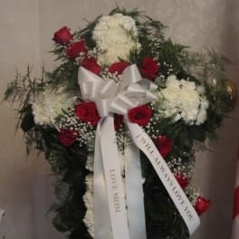Standing floral spray with red roses, white blooms, and a white ribbon