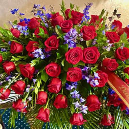 Large bouquet of red roses with blue and purple flowers