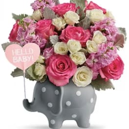 Pink and white rose bouquet in a gray elephant vase with a "Hello Baby!" heart pick