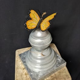 Butterfly ornament on a silver decorative pedestal