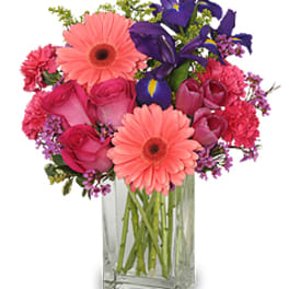 Pink and purple mixed bouquet in a clear glass vase