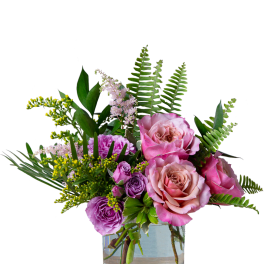 Pink and purple roses in a clear glass vase