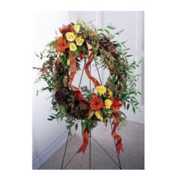 Floral wreath on a metal stand with red and yellow flowers