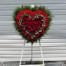Heart-shaped red rose wreath on a standing easel