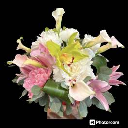 Bouquet of pink and white flowers with calla lilies in a box