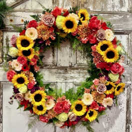Heart-shaped floral wreath with sunflowers and roses