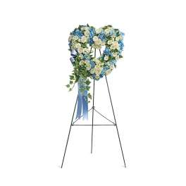 Heart-shaped blue and white standing wreath with roses and hydrangeas on a tall metal easel