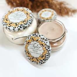 Three scented candles in glass jars with leopard-print lids