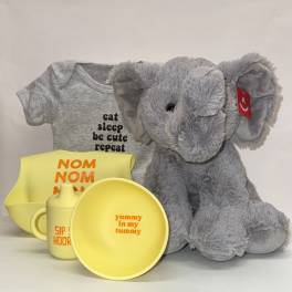 Baby gift set with gray elephant plush, gray onesie, and yellow feeding items