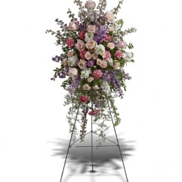 Tall pink and lavender standing floral spray on a metal easel