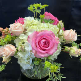 Pink roses and white hydrangeas in a glass vase