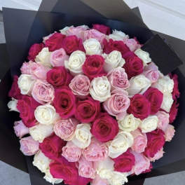 Bouquet of pink, white, and hot pink roses wrapped in black paper