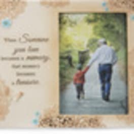 Blurred memorial card with a man and child walking on a path