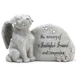 Memorial stone with a sleeping dog and engraved tribute text