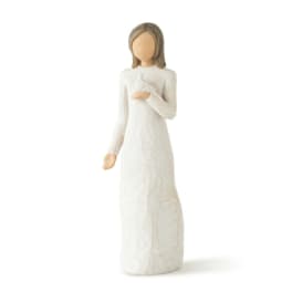 White figurine of a woman holding a bird