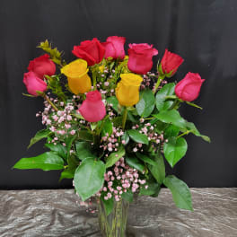 Bouquet of red and yellow roses in a glass vase