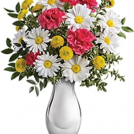 Bouquet of white daisies and pink carnations in a silver vase