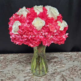 Pink and white rose bouquet in a clear glass vase