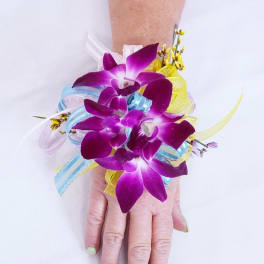 Purple orchid wrist corsage with blue and yellow ribbon accents