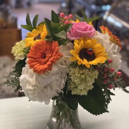 Colorful bouquet of mixed flowers in a clear glass vase