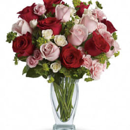 Bouquet of red and pink roses in a clear glass vase