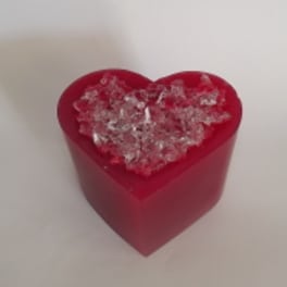 Red heart-shaped gift box filled with clear decorative crystals