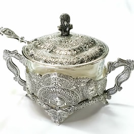 Ornate silver-toned lidded glass bowl with two handles