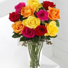 Bouquet of multicolored roses in a clear glass vase
