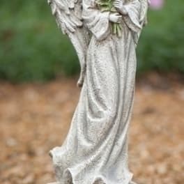 Angel statue holding pink roses with engraved text on the base