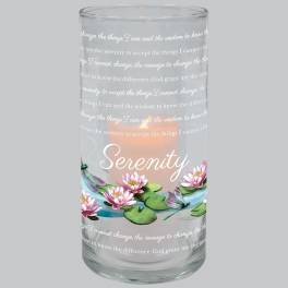 Glass candle holder with a lit candle and pink water lily design