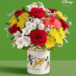 Bouquet of red roses, white lilies, and yellow chrysanthemums in a Disney tin