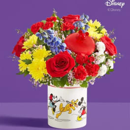 Colorful bouquet of roses, carnations, and daisies in a Disney-themed container