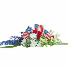 Red, white, and blue floral arrangement with small American flags