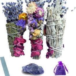Bundles of dried flowers and herbs with a purple sachet and a blue stone