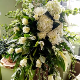 Large white floral standing spray with roses, hydrangeas, and chrysanthemums