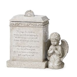 Stone memorial plaque with a praying angel figurine