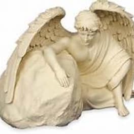 Beige angel figurine with folded wings and a seated figure