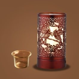 Decorative red candle warmer with a glass tealight holder
