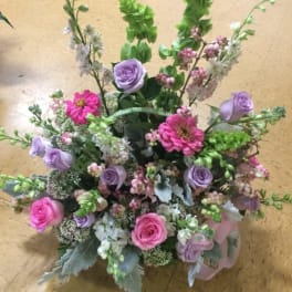 Mixed bouquet with pink and lavender roses and bright pink blooms